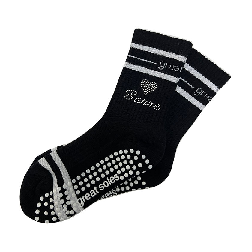 Jess black and white crew grip sock with a studded heart and  Barre detailed on it for home, at the Barre studio or out on the town