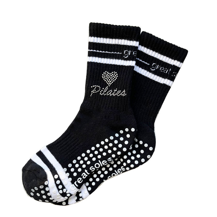 Jess black  and white crew grip sock with studded heart and pilates pattern pilates detailed on it for home, mat pilates or at the pilates studio